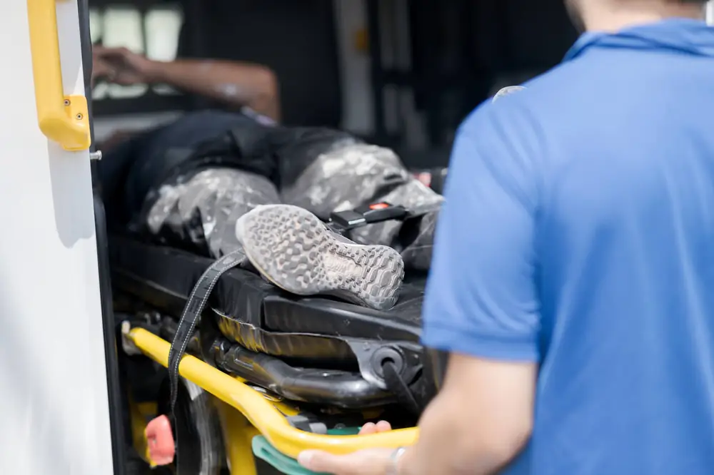 Paramedic loading a patient into the ambulance